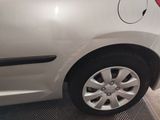 a small white car with a red stripe on the side of it