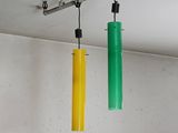 two green and yellow tubes hanging from the ceiling