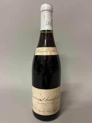 an old bottle of wine sitting on top of a table