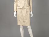 a woman ' s beige skirt suit and jacket on a mannequin mannequin mannequin mann