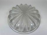 a clear glass cake plate with a decorative design on it