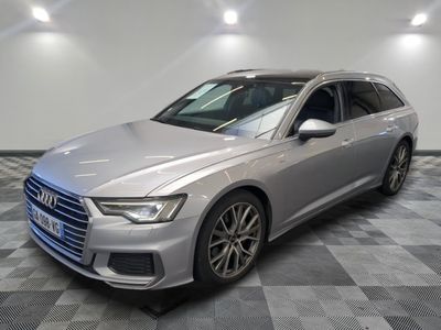 a silver audi is parked in a room with a checkered floor