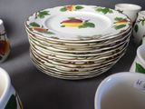 a stack of plates and cups sitting on a table