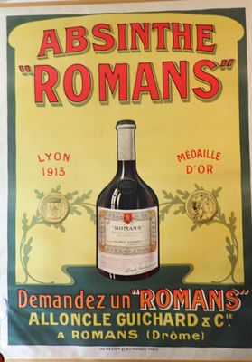 an old poster of a bottle of wine on a wall