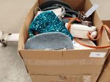 a cardboard box filled with assorted items on the floor