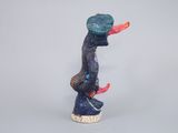 a figurine of a man with a hat on his head