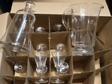 a cardboard box with a bunch of empty wine glasses in it
