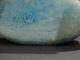 a blue and green vase sitting on a table