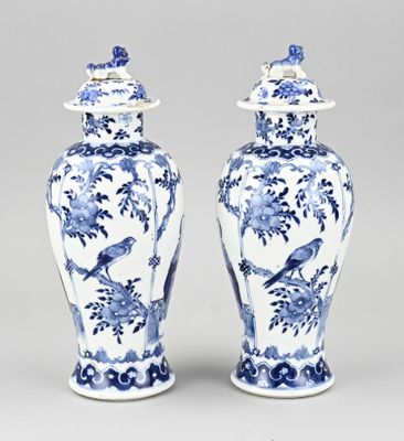 pair of blue and white vases with birds and flowers on them