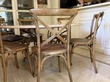 a table with four chairs and an umbrella in the kitchen