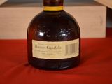 a bottle of liquor sitting on a red table cloth