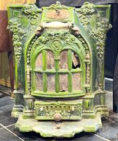 Poêle en fonte émaille verte à décor végétal.