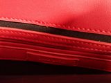 a close up of a red purse on a table