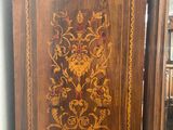 a wooden cabinet with a floral design on it