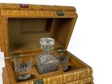 a wooden box with a bottle and glasses inside of it