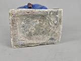 a stone block with a small blue object in it