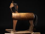 wooden rocking horse on a black background