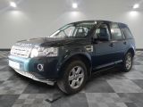 a picture of a blue land rover parked in a garage