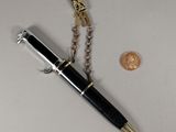 an image of a pen and a keychain on a table