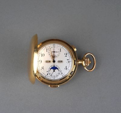 a gold pocket watch with a moon on the dial