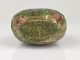 a close up of a green and brown object on a white surface