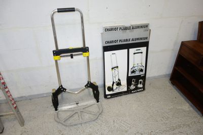 a small hand truck with a ladder next to it