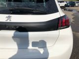 a white car parked in a parking lot with a shadow of a man on the back of the car