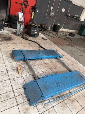 a blue piece of equipment on the floor in the garage