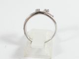 a close up of a silver ring with two diamonds on it