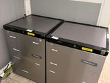 two refrigerators that are sitting in the corner of a room