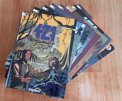 a bunch of comic books sitting on top of a wooden table