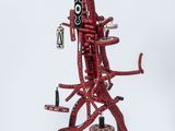 red sculpture of a man with a guitar on a white background