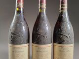 three bottles of wine sitting on top of a table next to each other