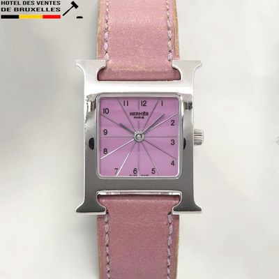 a pink watch with a square face on a pink leather strap