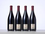 three bottles of wine are lined up on a table