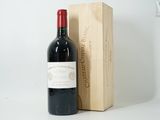 a bottle of red wine next to a wooden box