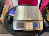 a scale that is on a table next to a chair