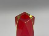 a red candle that is sitting on a white table