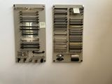 two pieces of metal hanging on the wall next to each other