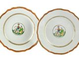 two plates with gold rims and a picture of a man and woman