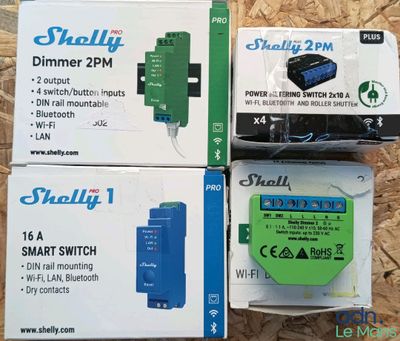 three boxes of small electronic devices sitting on top of a wooden surface
