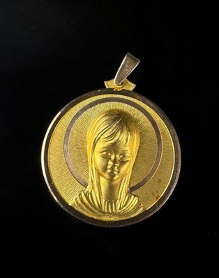 a close up of a gold medal on a black background