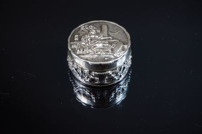 une pièce d'argent posée sur une surface noire