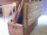 a large wooden box with a lot of items inside of it