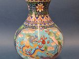 a blue vase with a dragon on it sitting on a table