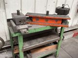 a work bench with tools on it in front of a building
