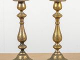 pair of antique brass candlesticks on a table