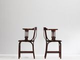 a pair of chairs in the style of person
