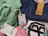 a pile of clothing and a tag on a table