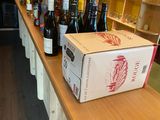 bottles of wine are lined up on a counter in a wine shop